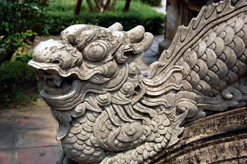Fototapeta na wymiar Sculpture of guarding dragon in buddist temple