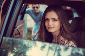 Portrait of cute girl in a car.