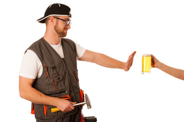 Handyman in work clothing refusing beer, don't drink on workplac