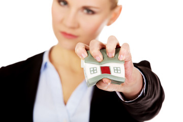 Aggresive business woman crushing small house