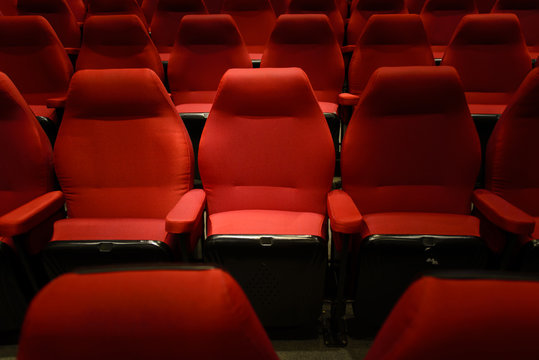 Empty red cinema chairs, red seats. Dark tone. Low-key