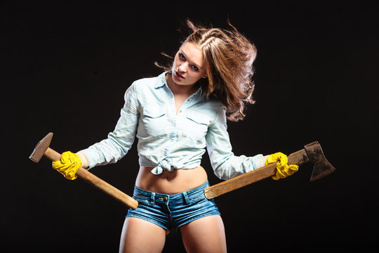 Sexy strong woman feminist with axes working.