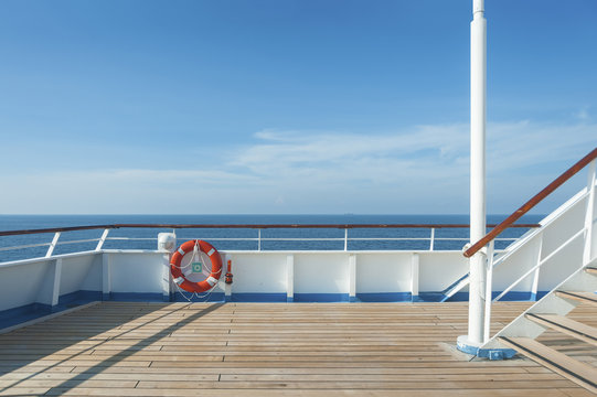 Ship deck, buoy and blue ocean. Travel background