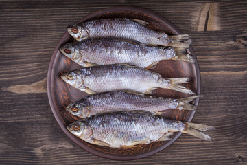 Dry fish on a wooden background