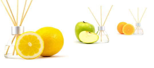 Air freshener sticks with a green apple, lemon and orange isolated on a white background
