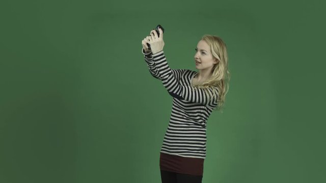 caucasian woman isolated on chroma green screen background selfie