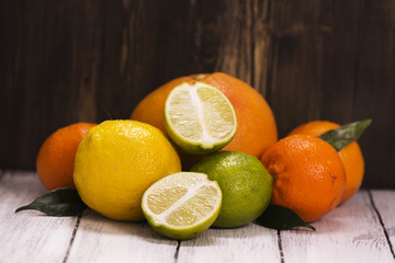 Pile of fresh citrus fruits over wooden background
