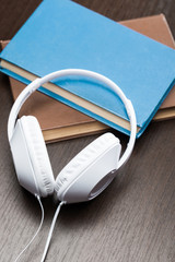 Audio books concept with old book and headphones