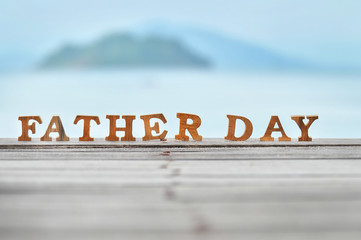 Happy father day concept, word of wooden father day on wood on sea view background idea