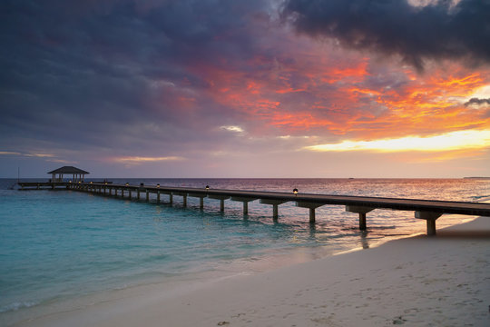 Awesome vivid sunset over the jetty in the Indian ocean.