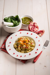 pasta with pesto pomegranate and sliced carrot