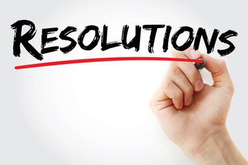 Hand writing Resolutions with red marker, business concept