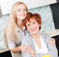 Woman with daughter on kitchen