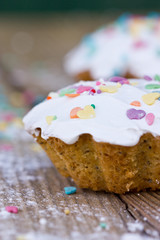 Vanilla muffin. Cupcake with white icing and colorful decorations
