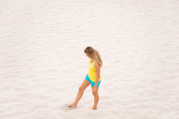 Tired woman standing on the beach