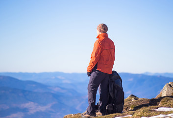 Naklejka premium Young happy treveller hiking in beautiful mountains. Fantastic autumn landscape