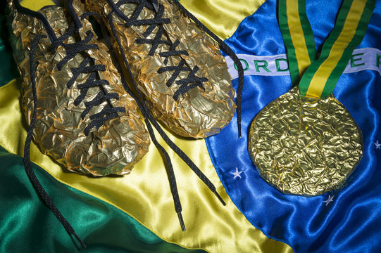 Golden running shoes resting with gold medal on shiny Brazilian flag still life 
