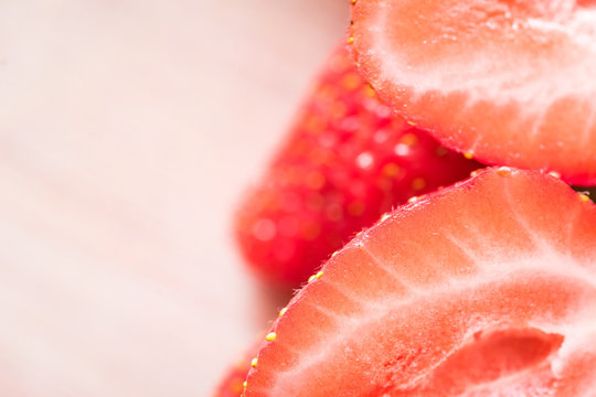 A fresh strawberries on a wooden table. Macro shot.
