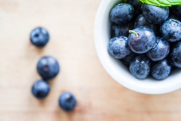 Top view of blueberries on a wooden table. Selective focus. Horizontal view.