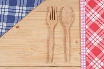 Color tablecloth, spoon, fork on  table background