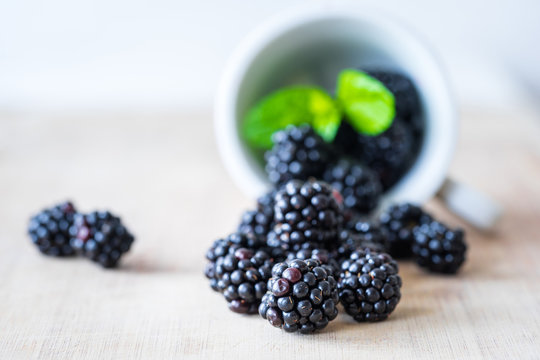 Blackberries on a wooden table. Selective focus. Horizontal view.