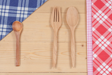 Wooden spoon and fork on wood texture of dining table