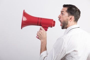 Business man holding a red loudspeaker