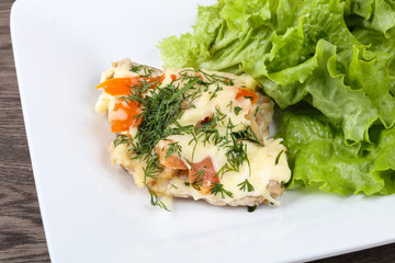 Meat covered cheese and tomato