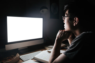 Man in glasses studying using blank screen computer