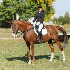 Young teenage girl riding horse. Equestrian sport