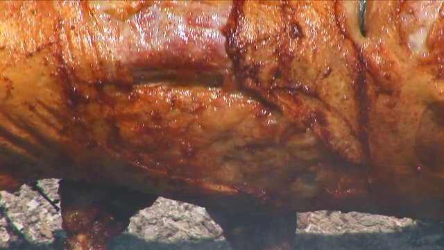 Roasting a lamb on a spit 