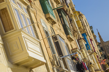 Valletta, Malta - The old houses and traditional maltese colorful balconies of Valletta at sunset
