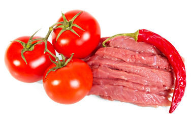 Slices raw meat, tomatoes and hot pepper isolated on white.