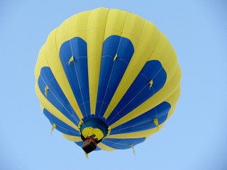 Yellow and blue hot air balloon over sky