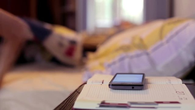 Man in Bed Wakes Up from a Phone