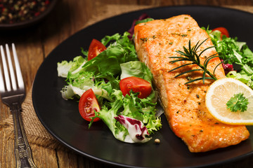 Baked salmon served with fresh vegetables.