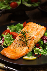 Baked salmon served with fresh vegetables.