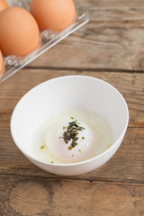 Soft-boiled egg or Onsen egg on wooden table.
