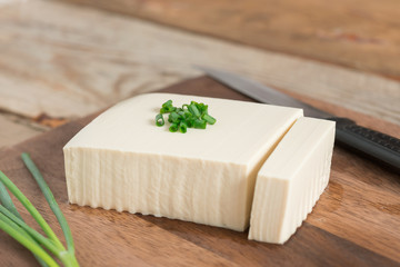 Fresh tofu on cutting board.