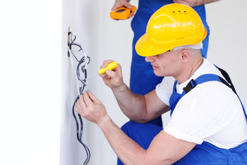 Builders working with electricity
