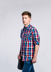 Fototapeta premium Boy in jeans and shirt, young man, studio shot