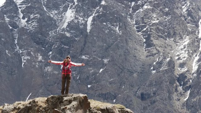 Woman in front of a huge rock