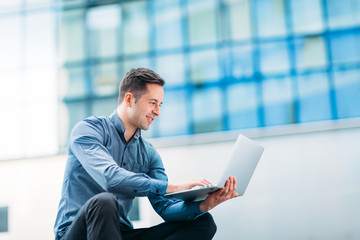 Man using a laptop outdoors