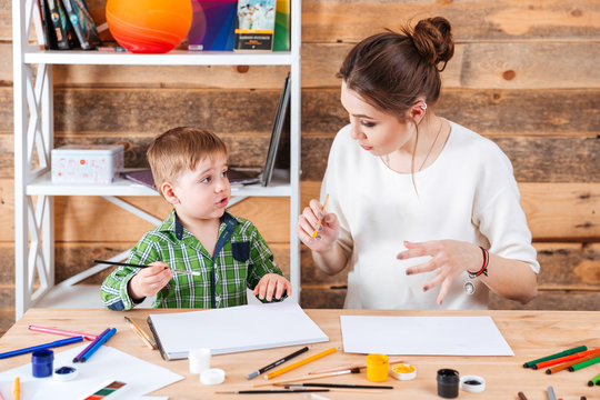 Mother and his cute little son painting together