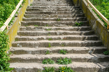 Abstract modern concrete stairs to building - stairway composition / stairs going up to the light / Empty white stairs in pedestrian subway with dull sky