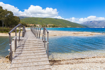 Wooden pedestrian bridge on greek beach