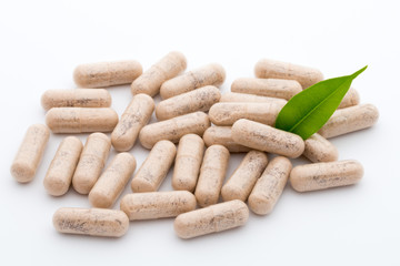 Ginkgo biloba capsule on the white background.