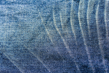 Blue denim jeans texture. blue jean fabric texture. Jeans background. Texture of blue jeans textile close up in vignette with copy space for text or image.