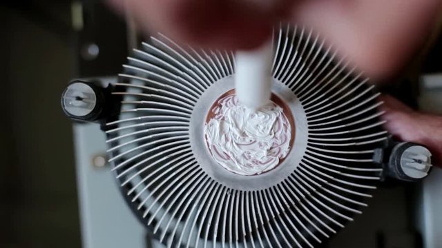 The worker applied thermal paste on the CPU
