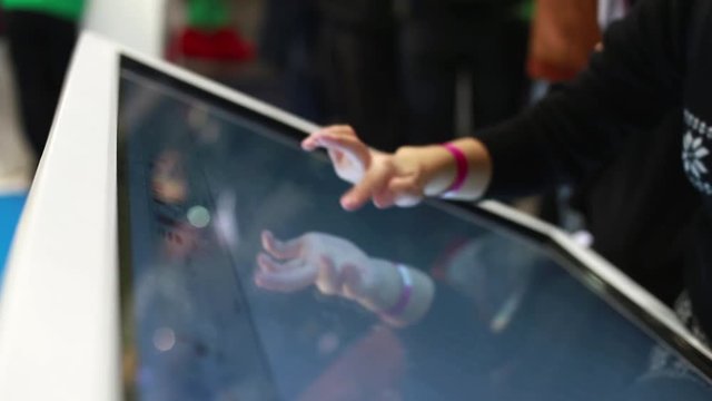 Woman Draws a Finger on the Large Touch Screen